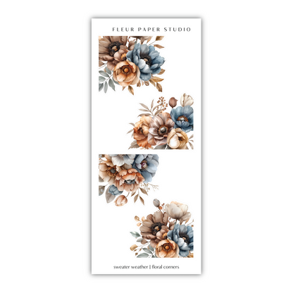 a white bookmark with blue and orange flowers